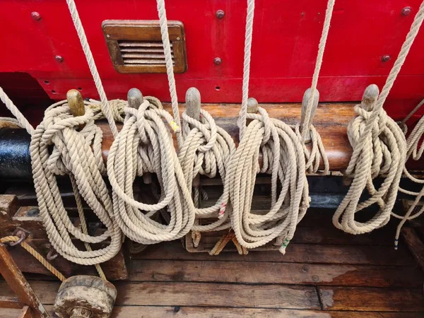 Strong ropes on an old wooden sailing ship are necessary for the team to travel the seas.