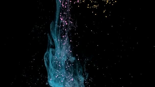 Colored dust on a black background, falling locally from top to bottom in slow motion — Vídeo de Stock