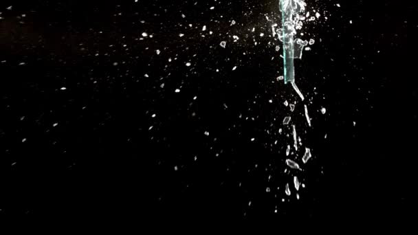 Fragments of broken glass fly in different directions on a black background. — Vídeo de Stock