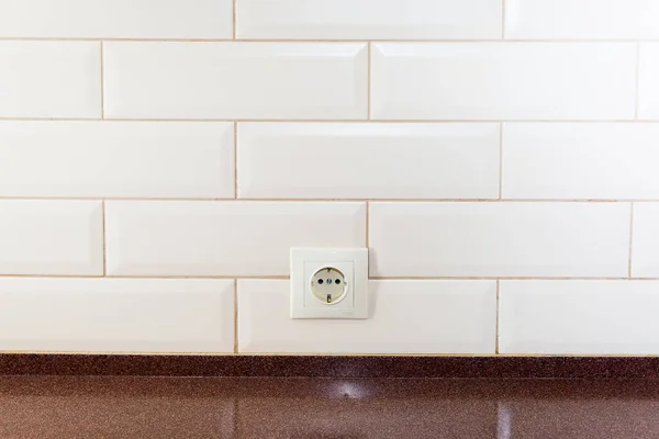 EU socket on the wall of tiled tiles in the kitchen — Stock Photo, Image