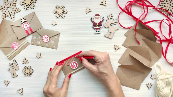 Woman Makes Christmas Advent Calendar Kids Decorates Envelope White Pencil — Stock Photo, Image