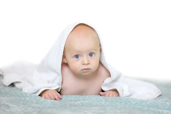 Little baby boy smiling under white towel. — Stock Photo, Image