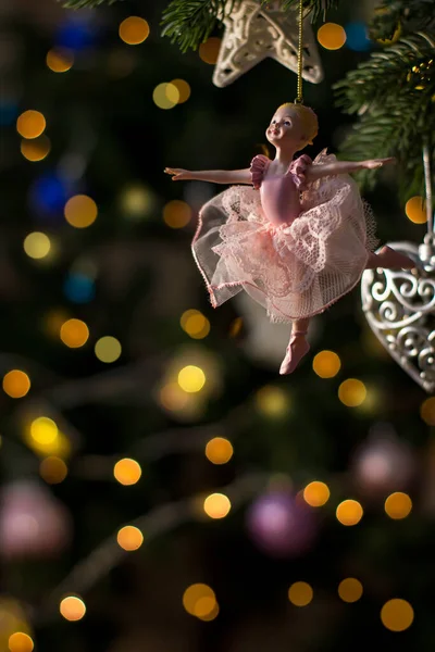 Ballerina toy figurine on Christmas tree. Holiday background. — Stock Photo, Image