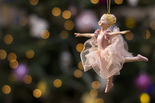 Ballerina toy figurine on Christmas tree. Holiday background. — Stock Photo, Image