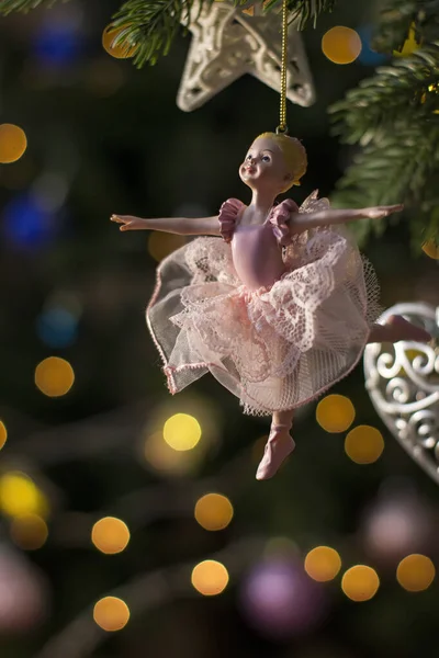 Ballerina toy figurine on Christmas tree. Holiday background. — Stock Photo, Image
