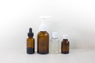 Various glass bottles for cosmetics, essential oils, natural medicine products or other liquids isolated on a white background. Front view.