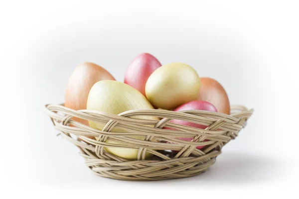 Golden, bronze and pink Easter eggs in basket isolated on white background. Design element for greeting cards, poster or banner.