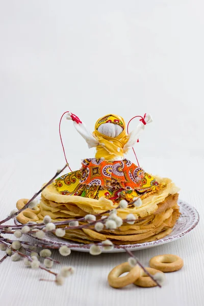 Background with pancakes, textile doll, sushki and pussy-willow on white for Maslenitsa festival. Traditional Russian meal for Shrovetide. Greeting card or poster. Copy space.