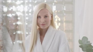 Kameraya bakan, doğal makyajlı, çekici sarışın bir kadının portresi. Cilt bakımı spa prosedürlerinin reklamını yapmak. Yakın plan portre