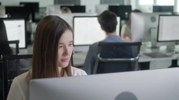 Atractiva joven mujer que trabaja en Decjalá Computadora mientras trabaja en Big Open Space Office. Retrato de negocios positivos Mujer mirando la pantalla de la computadora en interiores. — Vídeos de Stock