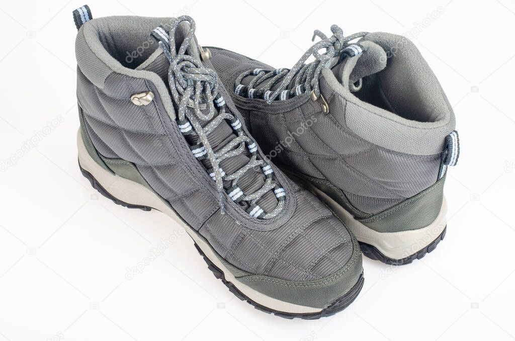 Winter waterproof insulated sports shoes on white background. Photo