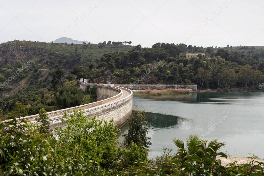 A view of the reservoir lake Marathon (Greece) stone bridge and mountains around on a spring day