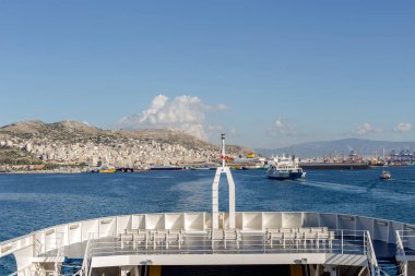 View of the port, parked ships, marina and passenger ferry on a winter, sunny  day (Perama, Greece)