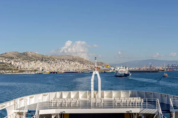 View of the port, parked ships, marina and passenger ferry on a winter, sunny  day (Perama, Greece)