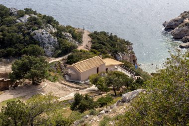 The panoramic view of the ancient church St. John the sea and the mountains on a summer day (prefecture of Corinthia, Greece).