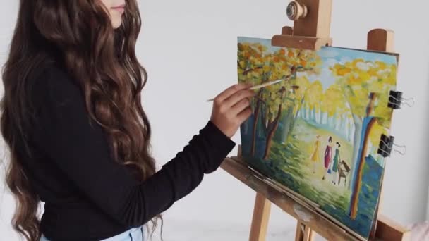 Young woman artist painting picture on canvas in art studio — 비디오