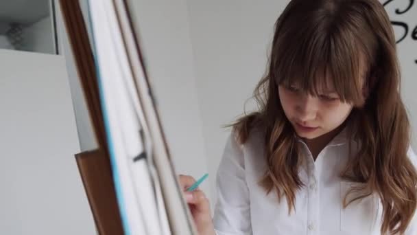 Peinture d'enfant sur chevalet, enfant de l'école en classe d'atelier. Jeune fille travail art artisanat dans la salle de classe — Video