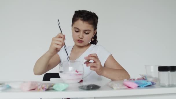 Girl mixes everythig together with black and white straw — Wideo stockowe