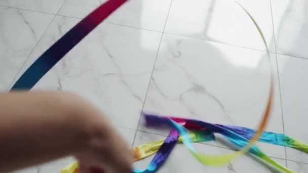 Girl makes moves with colourful ribbon — Stock Video