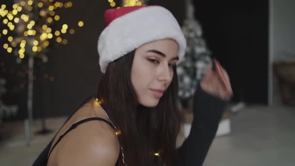 Portrait of hot brunette in new years hat smiling at camera — Wideo stockowe