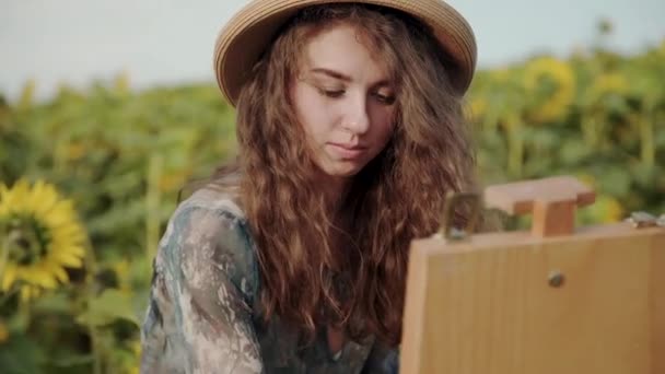 Portrait of happy lady painting with watercolours among beautiful sunflowers — Stockvideo
