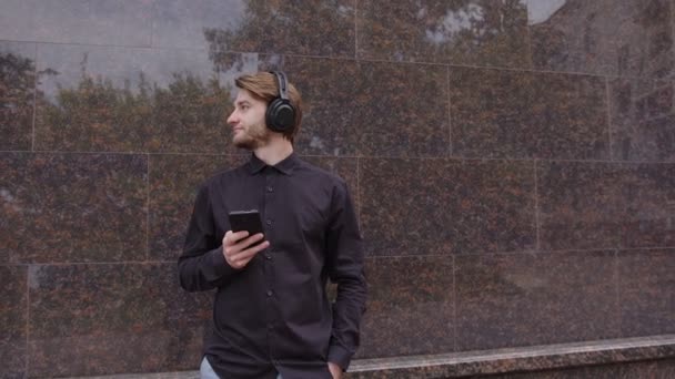 Knappe man in koptelefoon luisteren naar muziek — Stockvideo