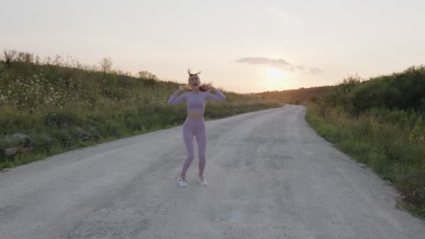 Flicka hoppar och vänder sig om i en frisk luft — Stockvideo