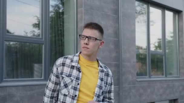 Student w okularach i rozmawiający na smartfonie — Wideo stockowe
