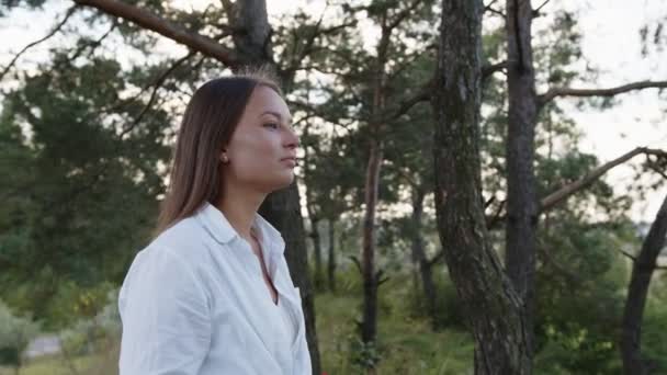 Attraktive Teenie-Mädchen mit natürlichem Make-up in der Natur Landschaft. Sanftes Lächeln, posiert draußen. — Stockvideo
