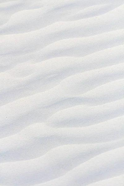 White sand texture. White sand background. vertical background