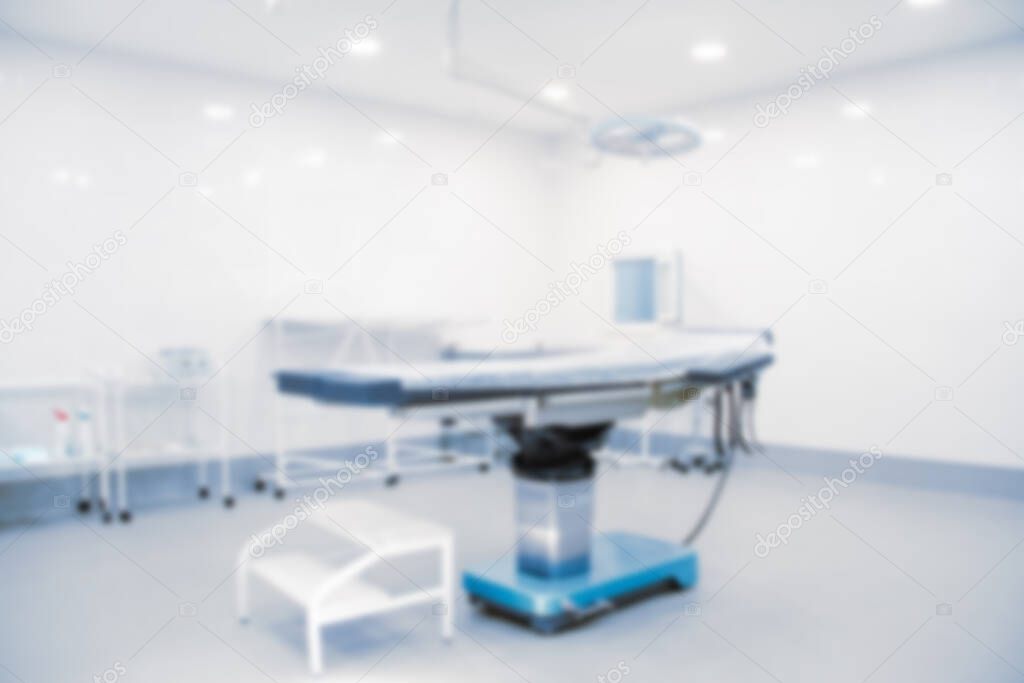 Blurry empty interior operating room and modern equipment in hospital.Medical device for surgeon surgical emergency patient in blue tone style.Save life medical treatment concept