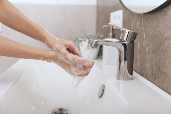 Washing hands under the flowing water tap. Washing hands rubbing with soap for corona virus prevention, hygiene to stop spreading corona virus in or public wash room. Hygiene concept hand detail — Stock Photo, Image