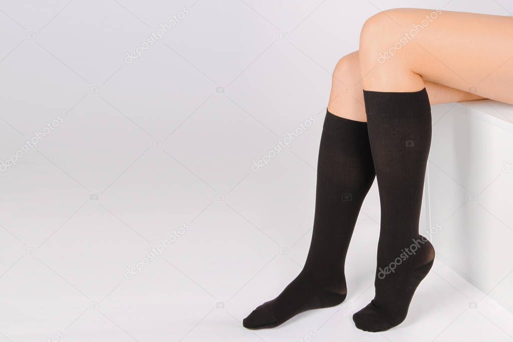 Medical Compression Stockings for varicose veins and venouse therapy. Compression Hosiery. Sock for sports isolated on white background. Black color socks mock up for advertising, branding, design