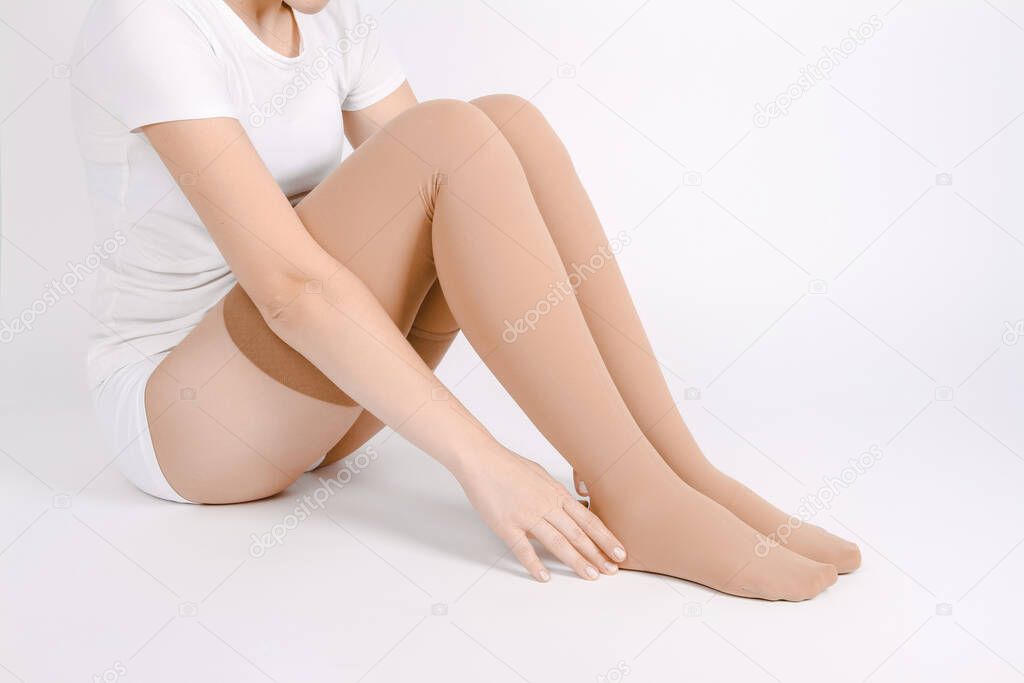 Beige compression stockings isolated on a white background