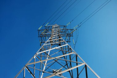 Mavi gökyüzü üzerindeki yüksek voltaj kulesi, elektrik krizi