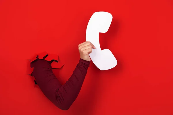 Hand Holding Handset Red Background Hotline Concept — Stock fotografie