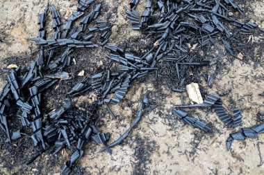 Metal ve plastik talaşlar yağmur damlalarıyla yerde yatıyor.