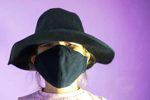 Girl Black Hat Black Mask Purple Background — стоковое фото