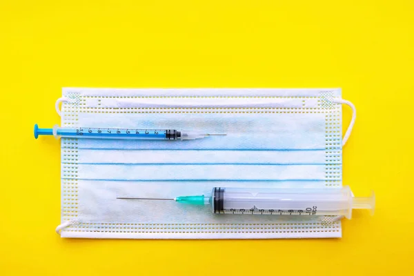 의료용 주사기들은 노란색 바탕에 위에서 아래까지 있습니다 백신을 접종하지 — 스톡 사진