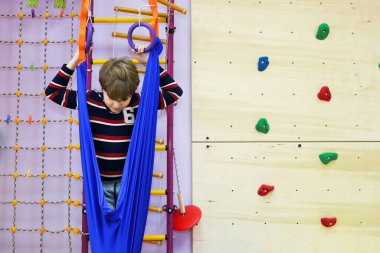 Çocuk, hastalıklı ve gelişimsel engelli çocuklar için bir rehabilitasyon merkezinde tırmanış eğitimi alarak çocuklarla iletişim kurmayı öğrenir.