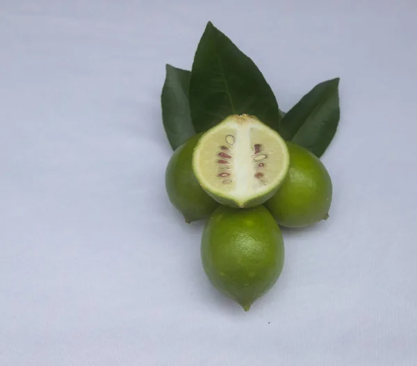 Fresh green lemon slice pieces with leaf. Testy lemon fruits. Refreshing summer drink ingredient