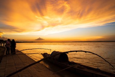 A wooden boat On Sea Against  Sky During Sunset