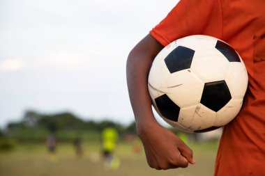 Man holding a soccer ball on the Playground  