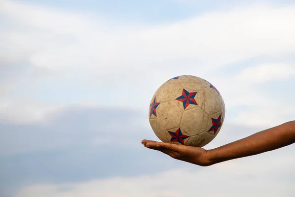 Old Dirty Soccer Ball  on the hand