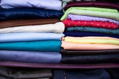 Patterned Textile Fabrics  stacked on a retail Shop Shelf for sale