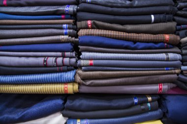 Patterned Textile Fabrics  stacked on a retail Shop Shelf for sale