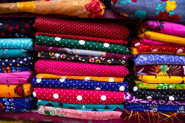 Artistic variety shade tone colors Textile Fabrics stacked on retail Shop Shelf to sale