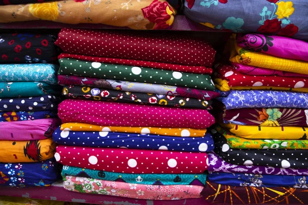 Artistic variety shade tone colors Textile Fabrics stacked on retail Shop Shelf to sale