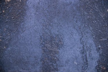 Old metal surface covered black ash  abstract background texture