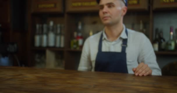 Customer Pays for Take Away with Contactless NFC Payment Technology on Smartphone to a Handsome Barista in bar or cafe. Customer Uses Mobile to Pay Through Bank Terminal. Close up — Stock Video